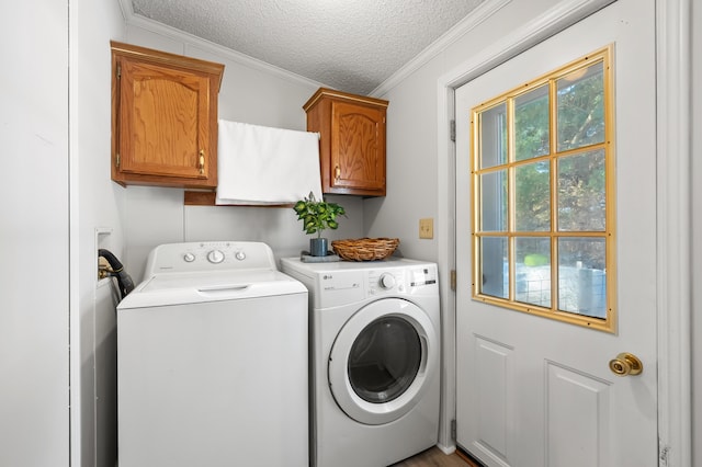 laundry room with independent washer and dryer, crown molding, cabinets, and a textured ceiling