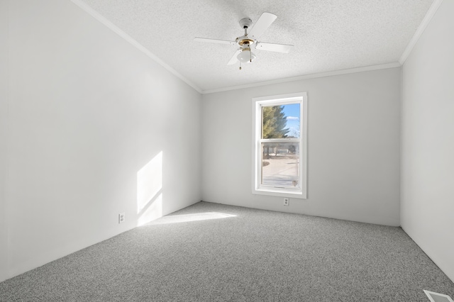 carpeted empty room with ceiling fan, crown molding, and a textured ceiling