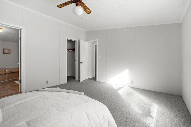 bedroom with crown molding, ceiling fan, connected bathroom, and a textured ceiling