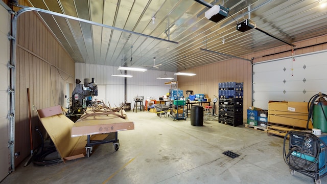 garage featuring a garage door opener and metal wall