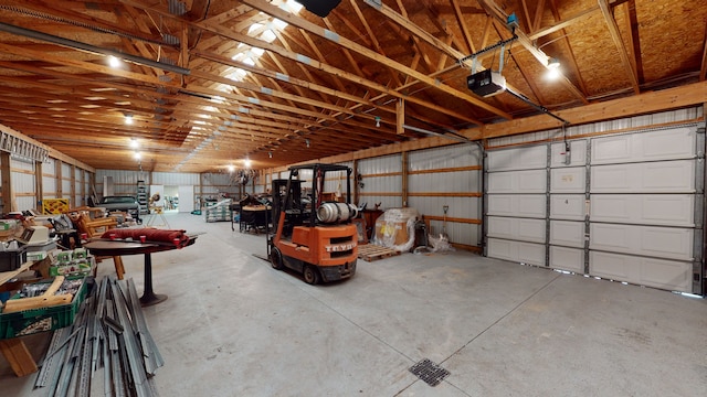 garage with a garage door opener and metal wall