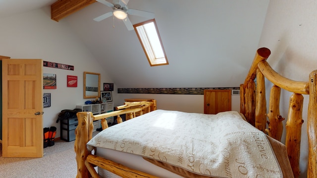 bedroom featuring carpet floors, vaulted ceiling with skylight, and a ceiling fan