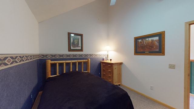 carpeted bedroom with vaulted ceiling and baseboards