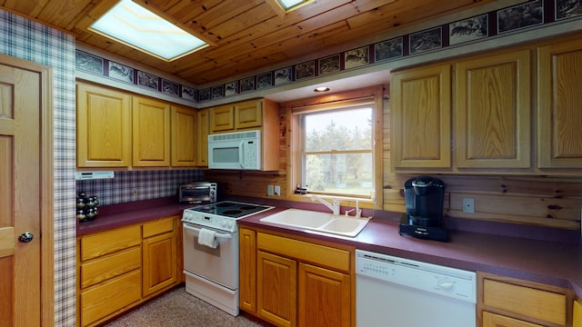 kitchen featuring wood ceiling, white appliances, a sink, and dark countertops