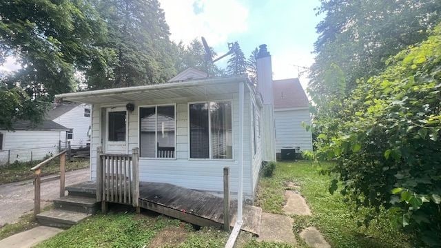 bungalow-style house featuring central AC unit