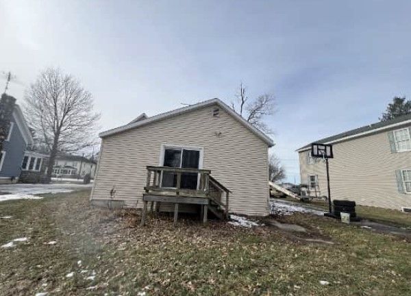 rear view of house featuring a yard