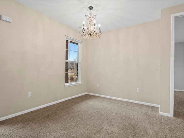 unfurnished room with carpet flooring and a notable chandelier