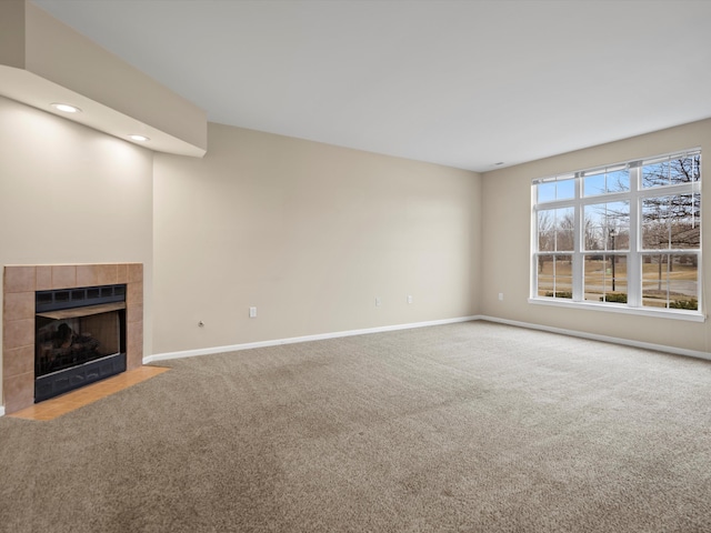 unfurnished living room with carpet flooring and a fireplace