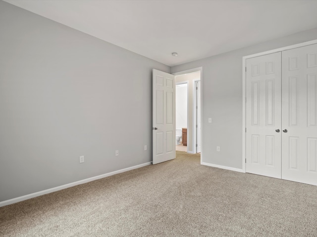 unfurnished bedroom with carpet flooring and a closet