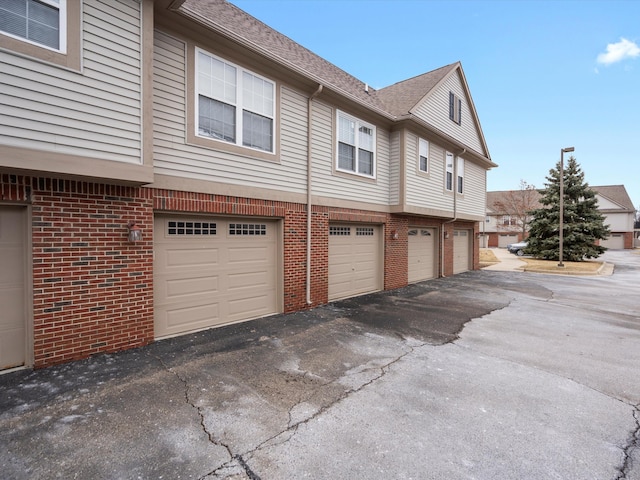 view of side of home with a garage