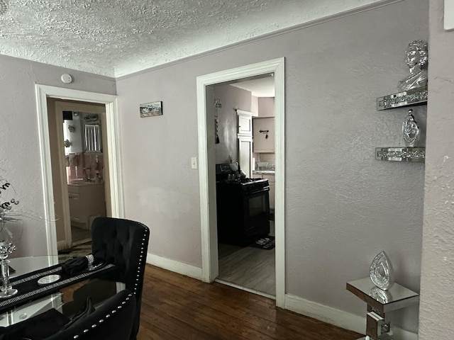 office area with dark hardwood / wood-style floors and a textured ceiling