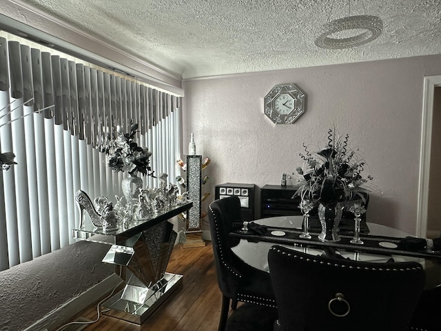 dining room featuring a textured ceiling and dark hardwood / wood-style flooring