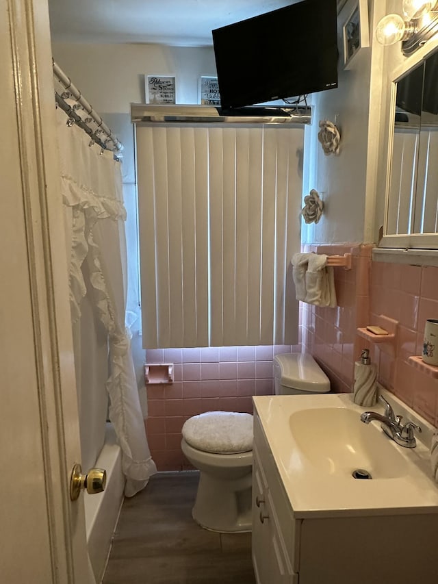 full bathroom with tile walls, vanity, wood-type flooring, and toilet