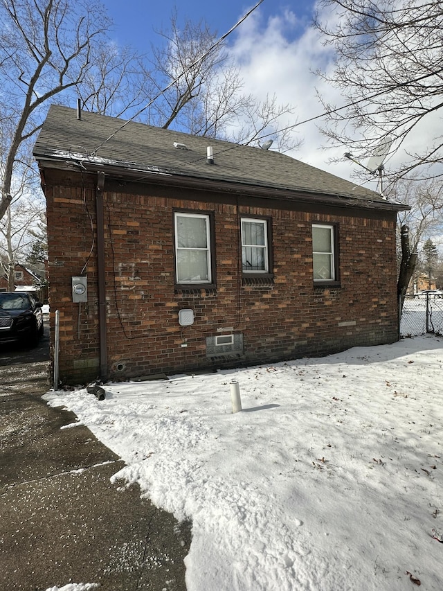 view of snow covered rear of property