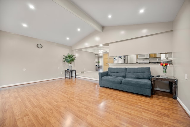 living room with vaulted ceiling with beams, ceiling fan, and light hardwood / wood-style flooring