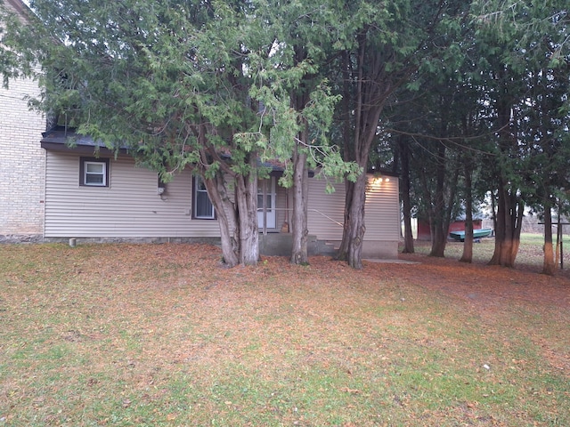 view of side of home featuring a lawn