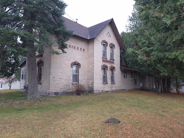 view of side of home with a yard