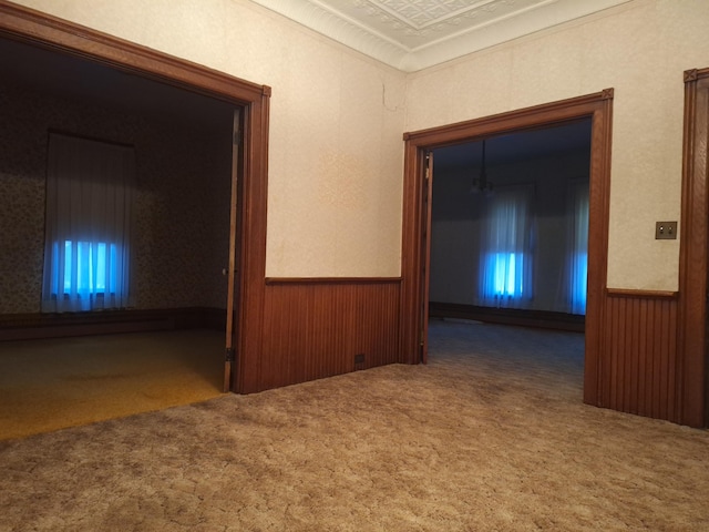 corridor featuring carpet flooring and wood walls