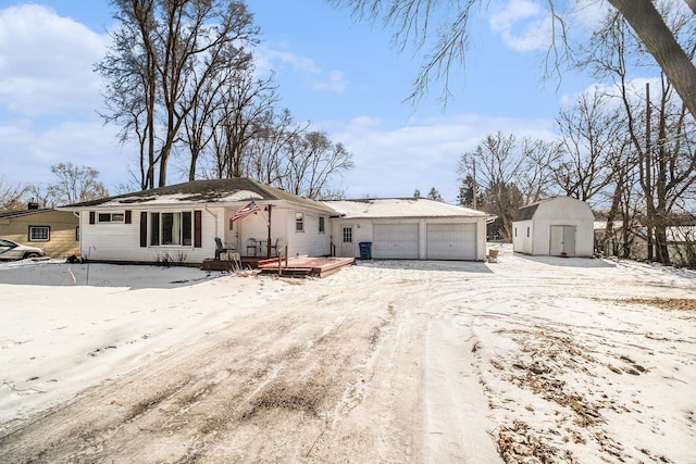 ranch-style home with a garage and a storage unit