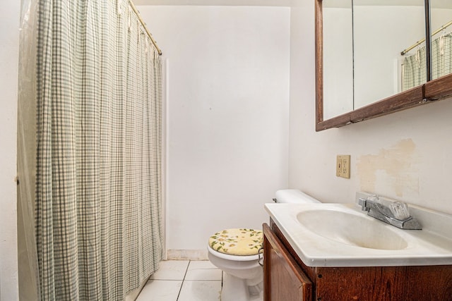 bathroom featuring tile patterned flooring, vanity, and toilet