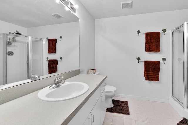 bathroom featuring vanity, tile patterned floors, toilet, and walk in shower