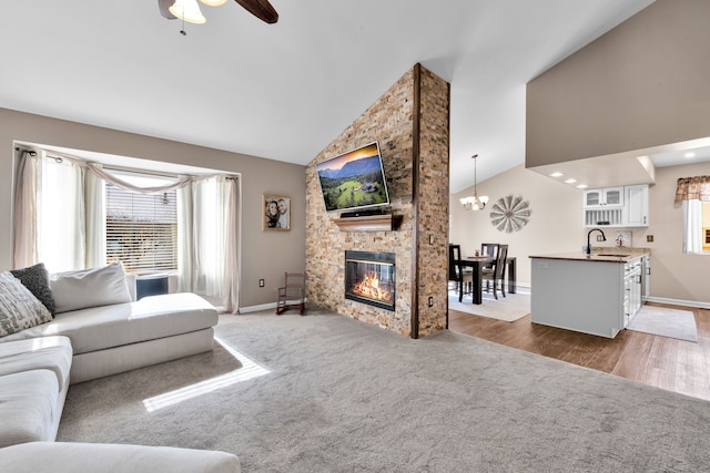 living room with dark carpet, plenty of natural light, a fireplace, and sink