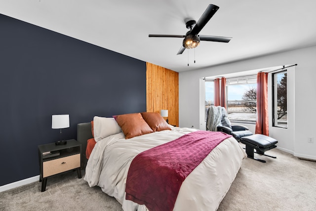 bedroom featuring light carpet and ceiling fan