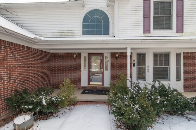 view of snow covered property entrance