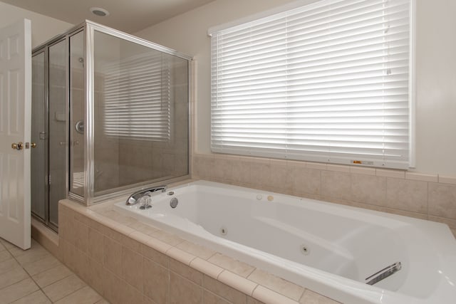 bathroom featuring a healthy amount of sunlight, tile patterned floors, and separate shower and tub