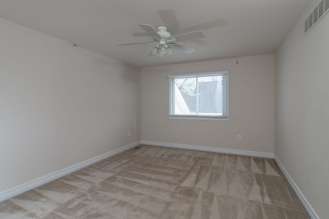 unfurnished room featuring ceiling fan and light colored carpet