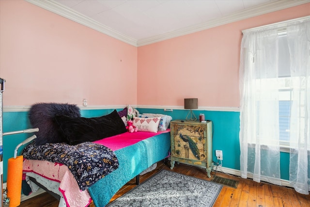 bedroom featuring crown molding and wood-type flooring