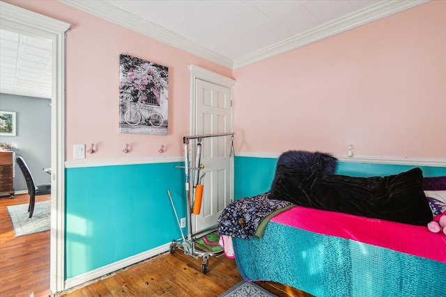 bedroom featuring hardwood / wood-style flooring and ornamental molding