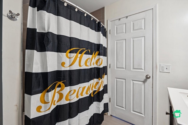 bathroom featuring vanity and a shower with curtain