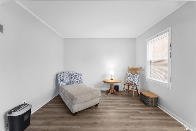 sitting room with ornamental molding and hardwood / wood-style floors