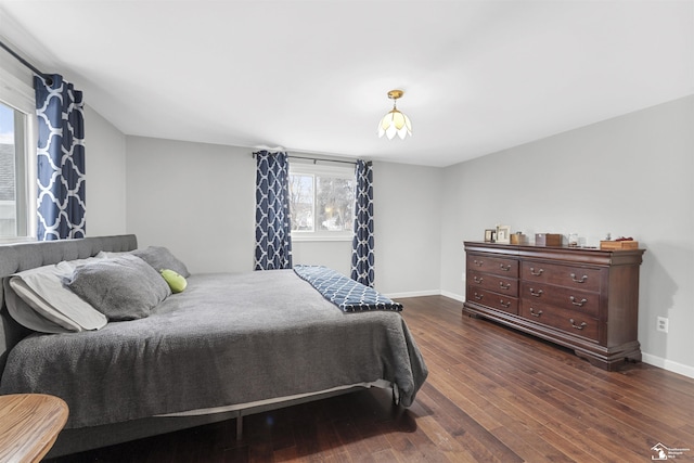 bedroom with dark wood-type flooring