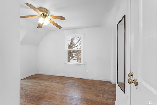 additional living space with lofted ceiling, hardwood / wood-style flooring, and ceiling fan