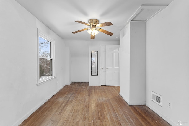 spare room featuring wood-type flooring and ceiling fan