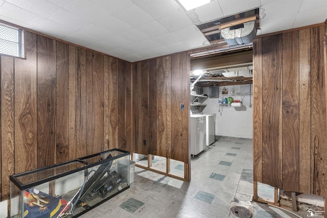 interior space featuring washer and clothes dryer and wooden walls