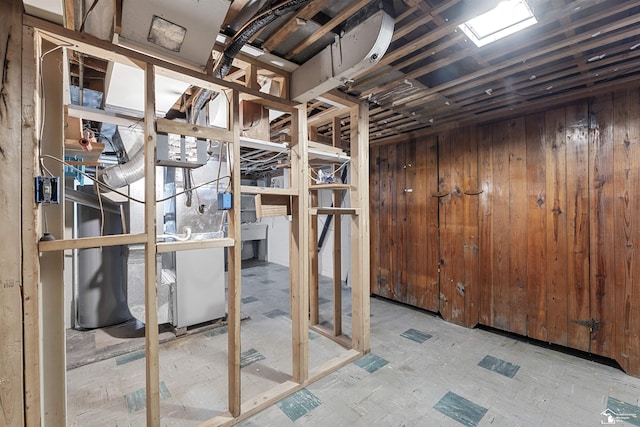 basement featuring wooden walls