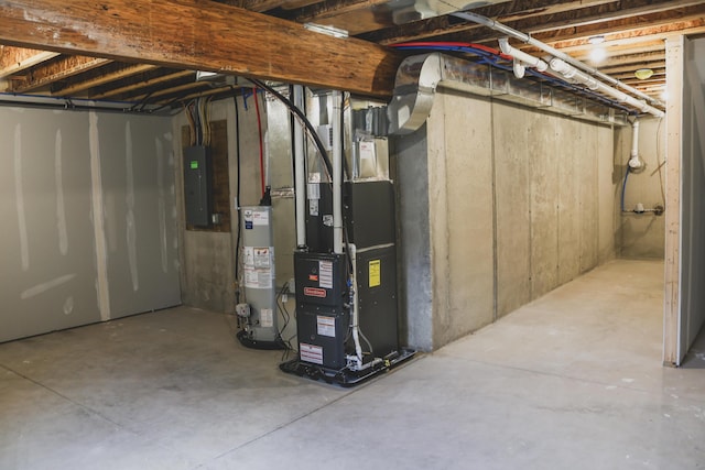 basement featuring heating unit, gas water heater, and electric panel