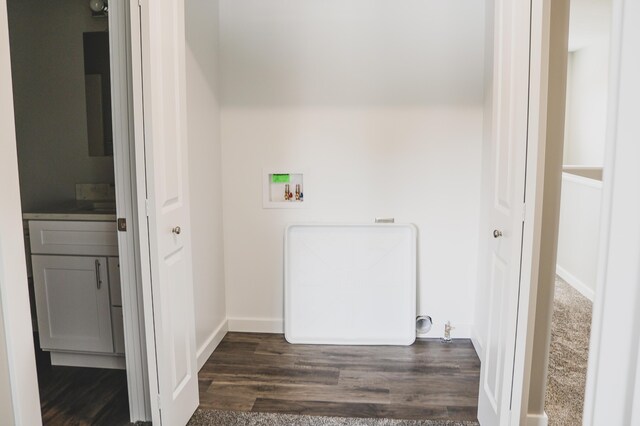 washroom with dark hardwood / wood-style flooring and washer hookup