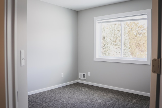 empty room with dark colored carpet