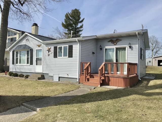 rear view of property featuring a lawn