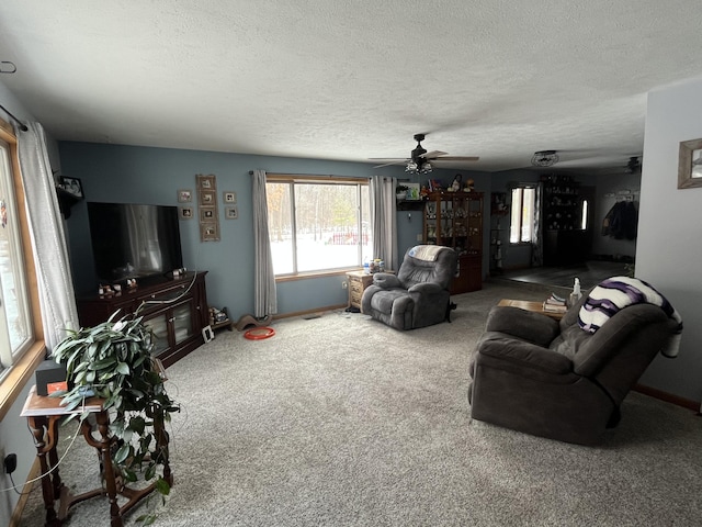 carpeted living room with ceiling fan and a textured ceiling