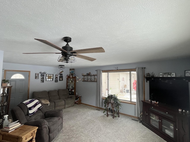 carpeted living room with a textured ceiling and ceiling fan