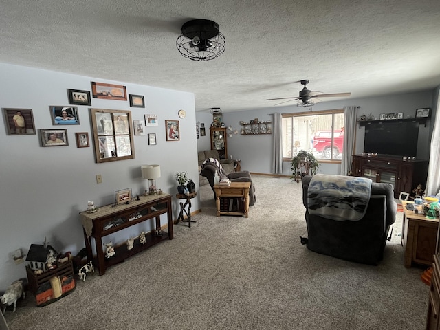 carpeted living room featuring ceiling fan and a textured ceiling