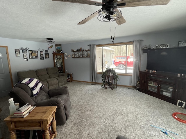 carpeted living room with ceiling fan and a textured ceiling