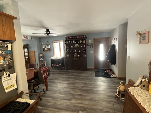 foyer entrance with dark wood-type flooring and ceiling fan