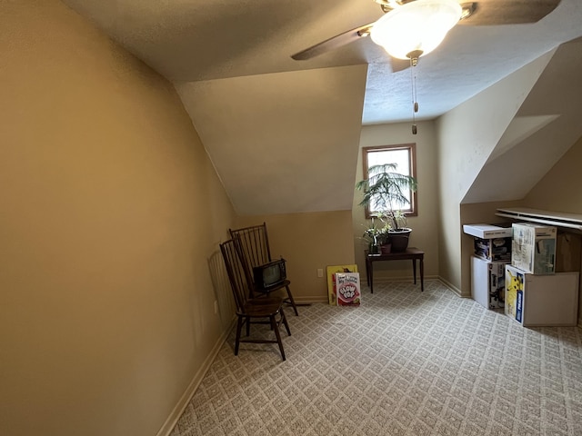 bonus room featuring ceiling fan, vaulted ceiling, and light carpet