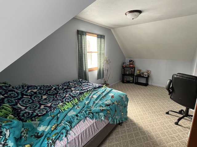 carpeted bedroom with lofted ceiling